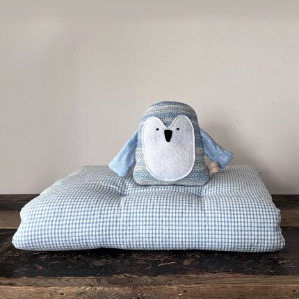 Lifestyle Image: OTT Quilt Blue and Knitted Penguin Toy